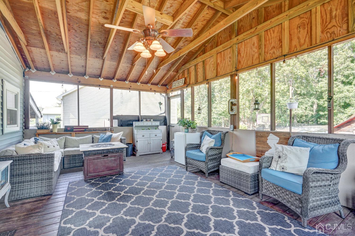 254 Manalapan Road Spotswood, NJ 08884 - Photo 25 of 41 a living room with patio furniture and a fireplace