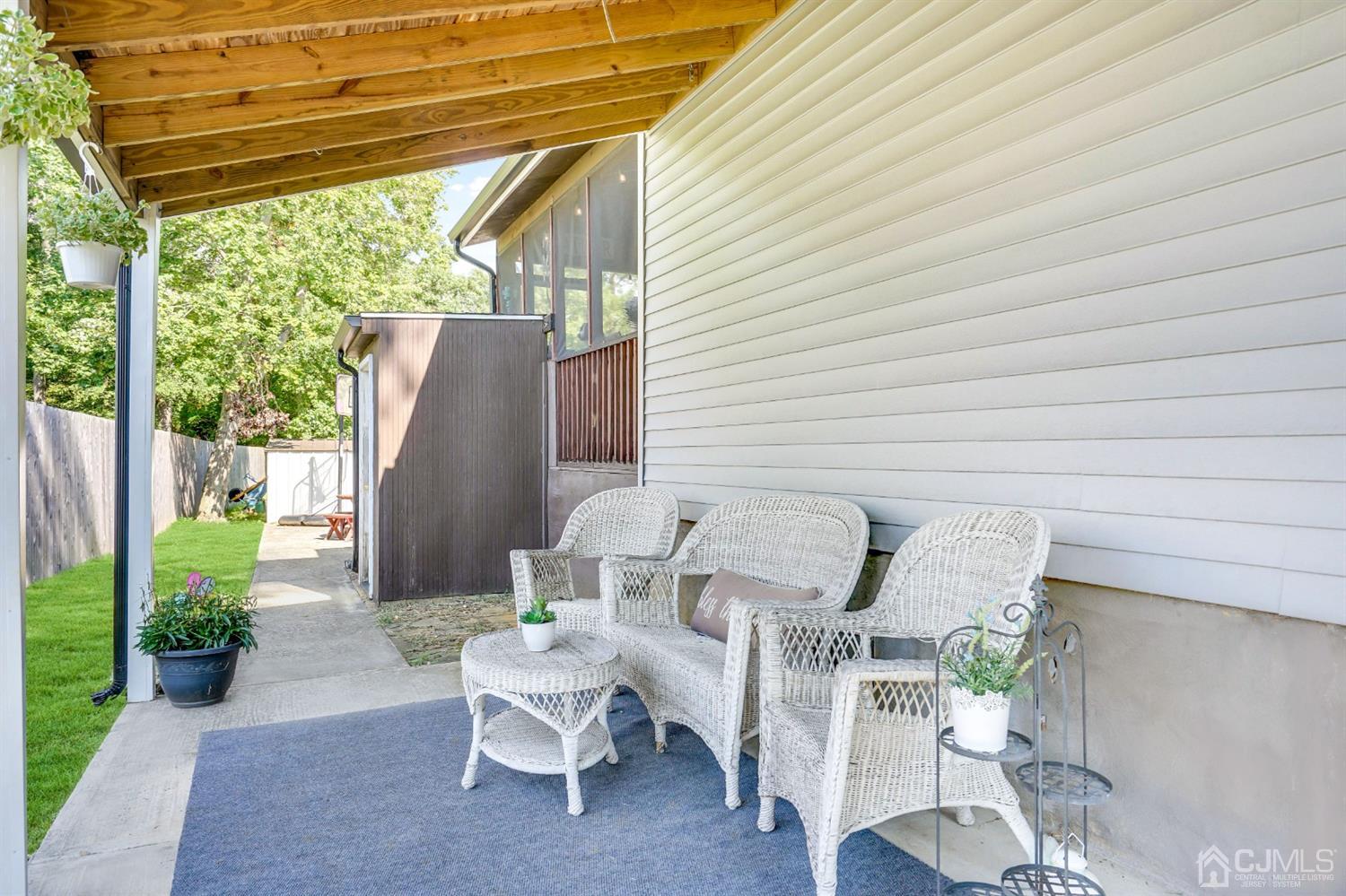 254 Manalapan Road Spotswood, NJ 08884 - Photo 28 of 41 a view of a patio with table and chairs and potted plants