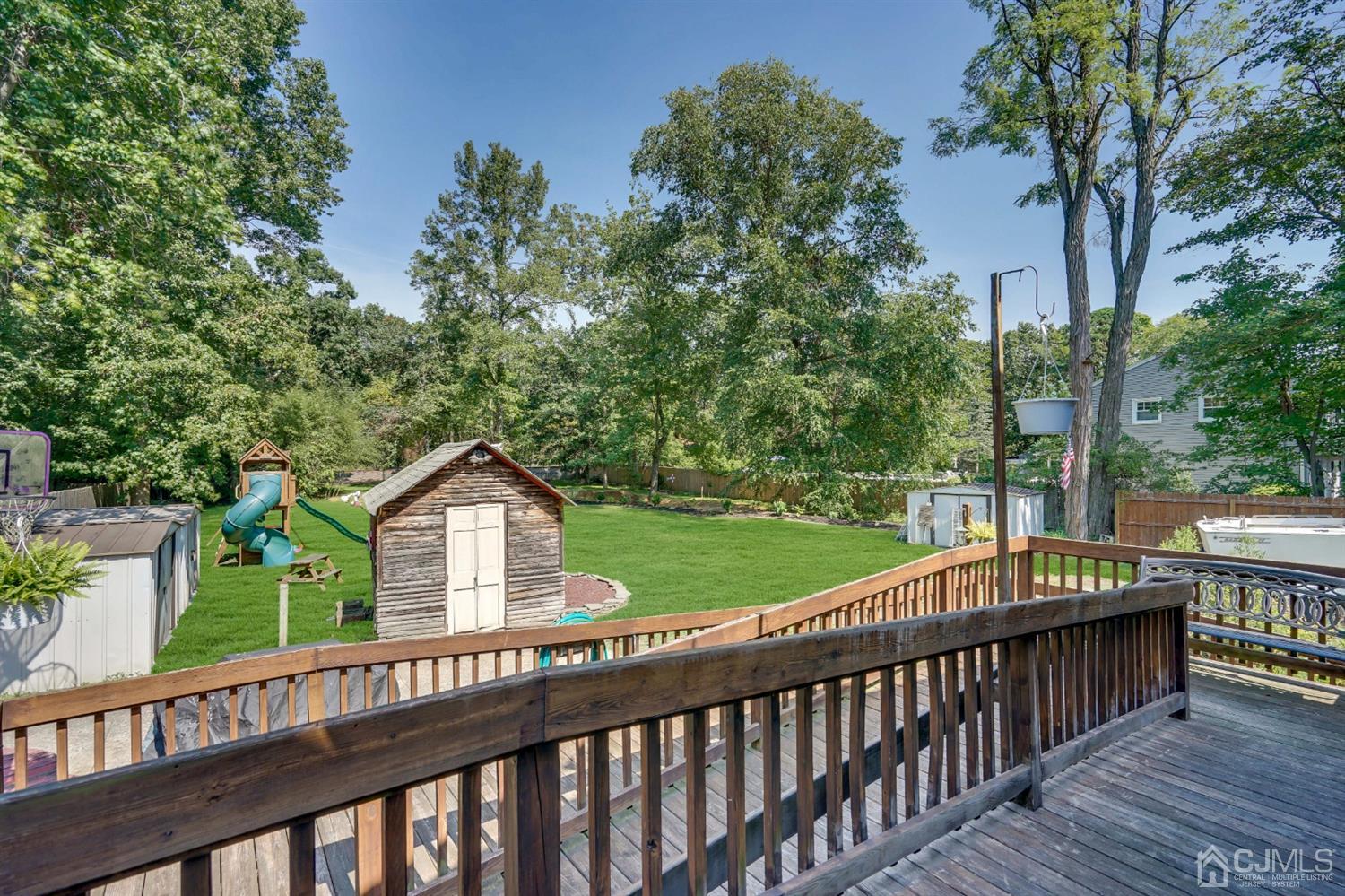 254 Manalapan Road Spotswood, NJ 08884 - Photo 30 of 41 a wooden deck with trees in front of it