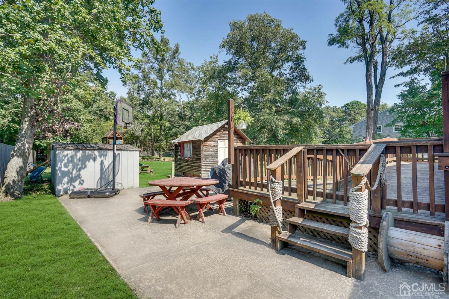 254 Manalapan Road Spotswood, NJ 08884 - Photo 36 of 41 a view of backyard with deck and garden