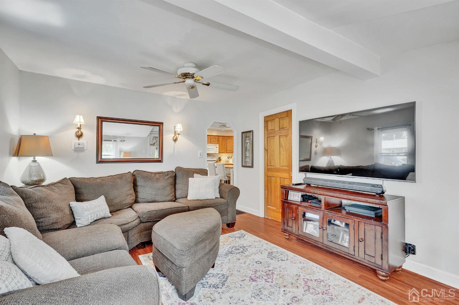 254 Manalapan Road Spotswood, NJ 08884 - Photo 6 of 41 a living room with furniture and a flat screen tv