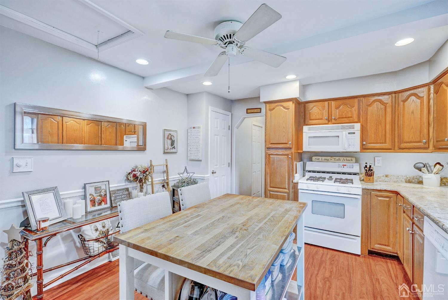 254 Manalapan Road Spotswood, NJ 08884 - Photo 9 of 41 a kitchen with a stove a sink dishwasher a refrigerator with wooden cabinets and floor