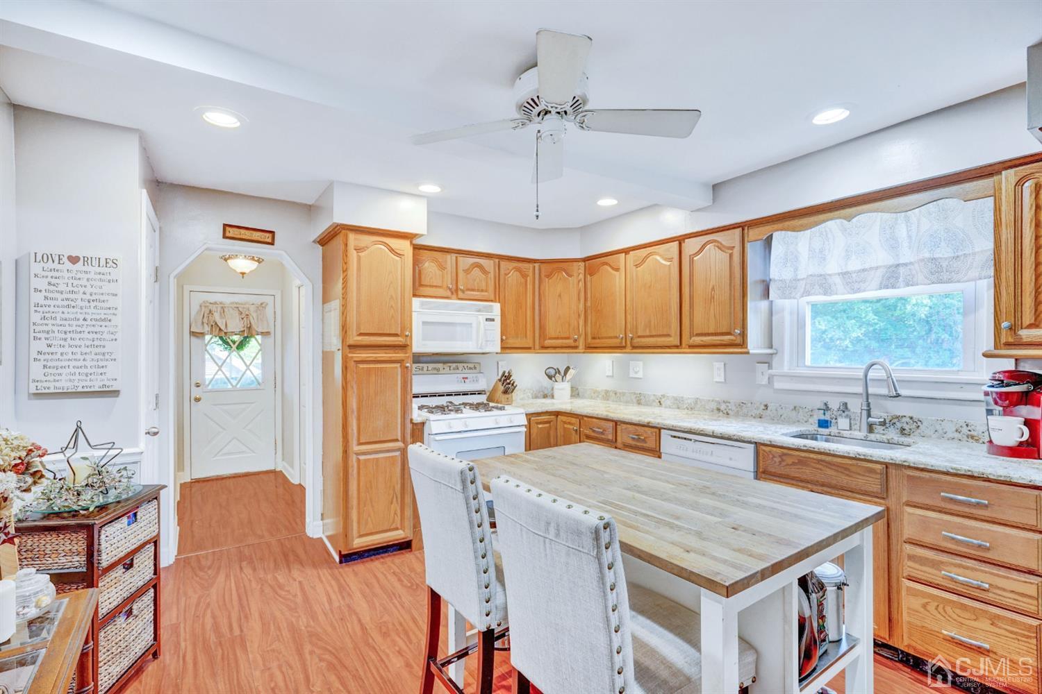 254 Manalapan Road Spotswood, NJ 08884 - Photo 10 of 41 a kitchen with a stove a sink a dining table and chairs