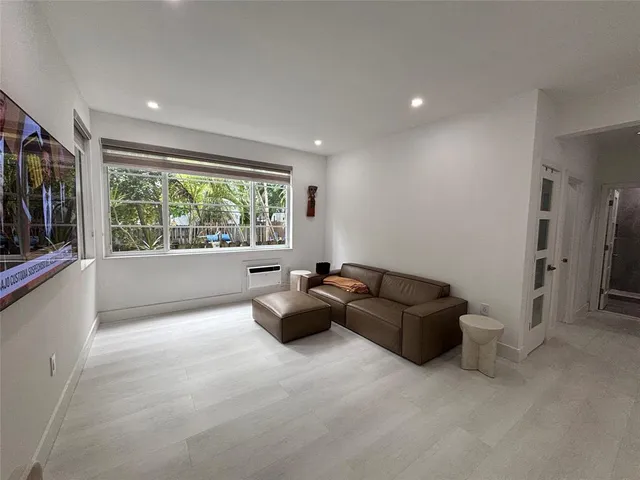 a living room with a couch and a window