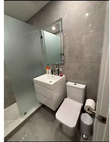 a view of a backyard with table and chairs with wooden fence and plants