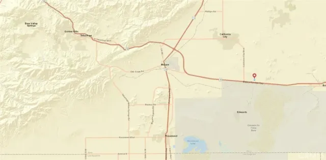 a white bed in a bathroom next to a window