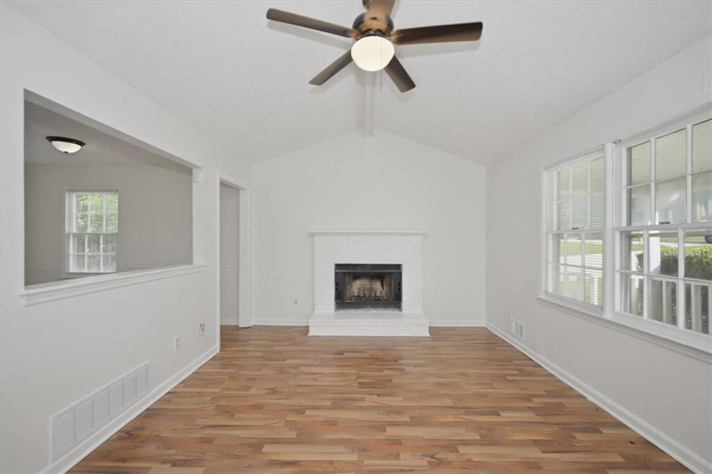 1496 Cherry Hill Road Southwest Conyers, GA 30094 - Photo 3 of 32 wooden floor chandelier and windows in a room
