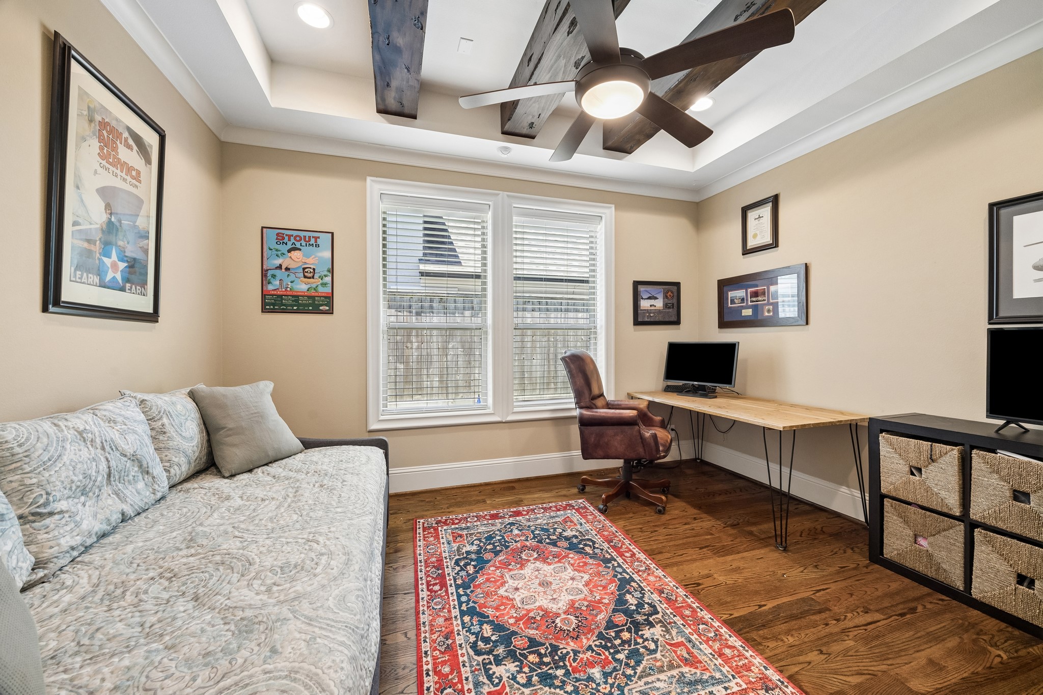1360 Chippendale Road Houston, TX 77018 - Photo 16 of 34 Versatile first-floor flex room tucked privately behind French doors and featuring exposed wood beams, tray ceiling, ceiling fan, and large windows. Ideal as a sophisticated home office, playroom, study, or additional living space.