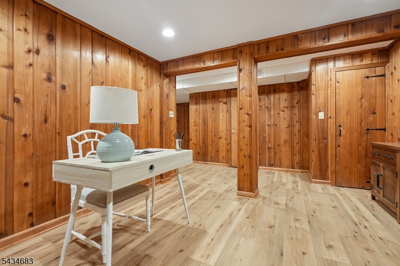 106 Division Avenue Summit, NJ 07901 - Photo 28 of 38 a view of a hallway with wooden floor and chair