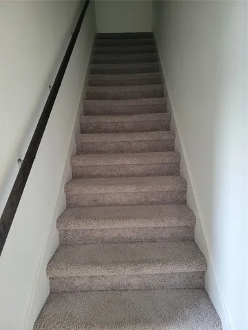 a white toilet sitting next to a white cabinet