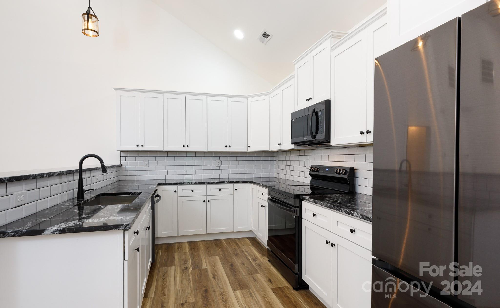 5040 Mt Gallant Road Rock Hill, SC 29732 - Photo 11 of 38 a kitchen with granite countertop a sink stove and refrigerator