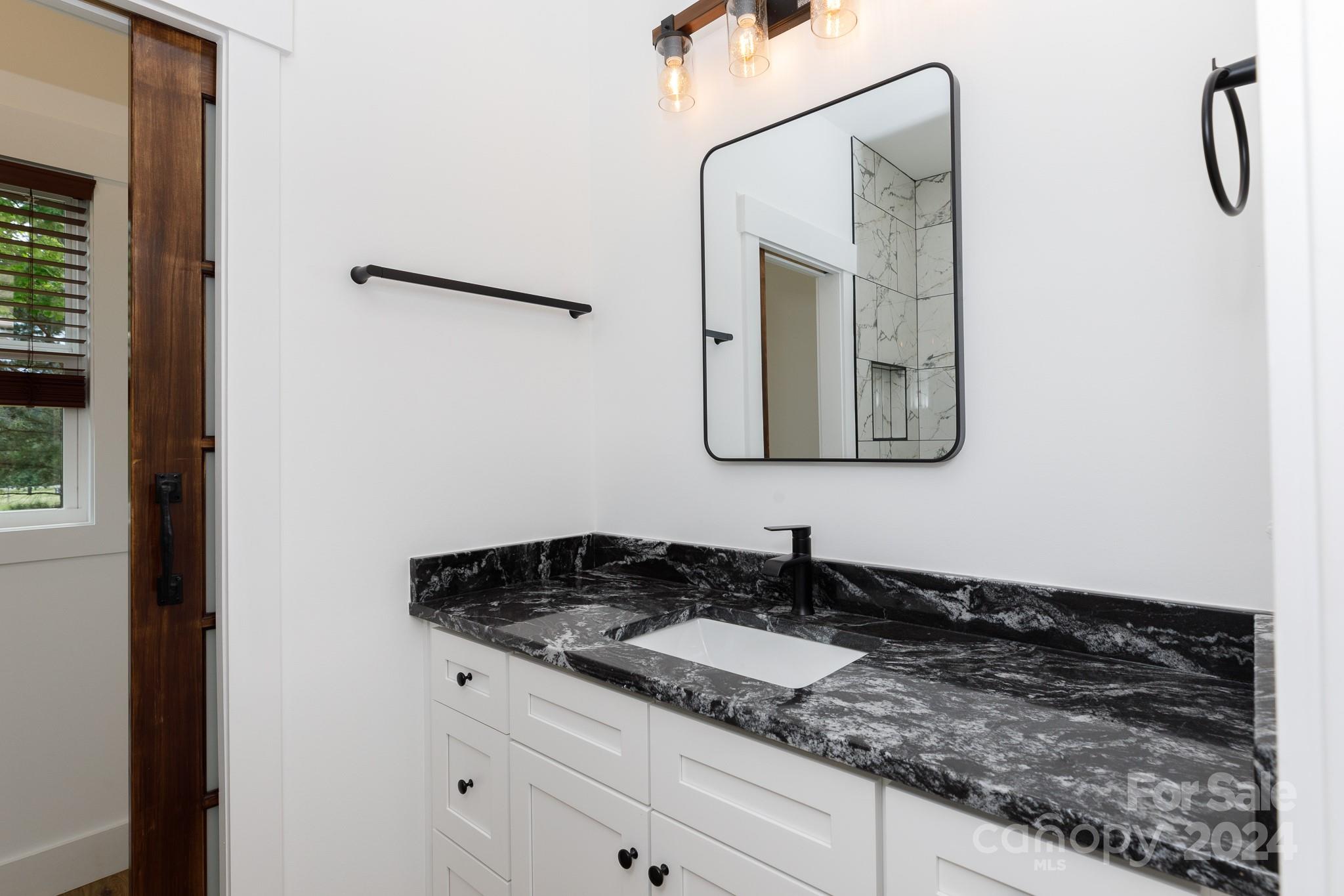 5040 Mt Gallant Road Rock Hill, SC 29732 - Photo 28 of 38 a bathroom with a granite countertop sink and a mirror