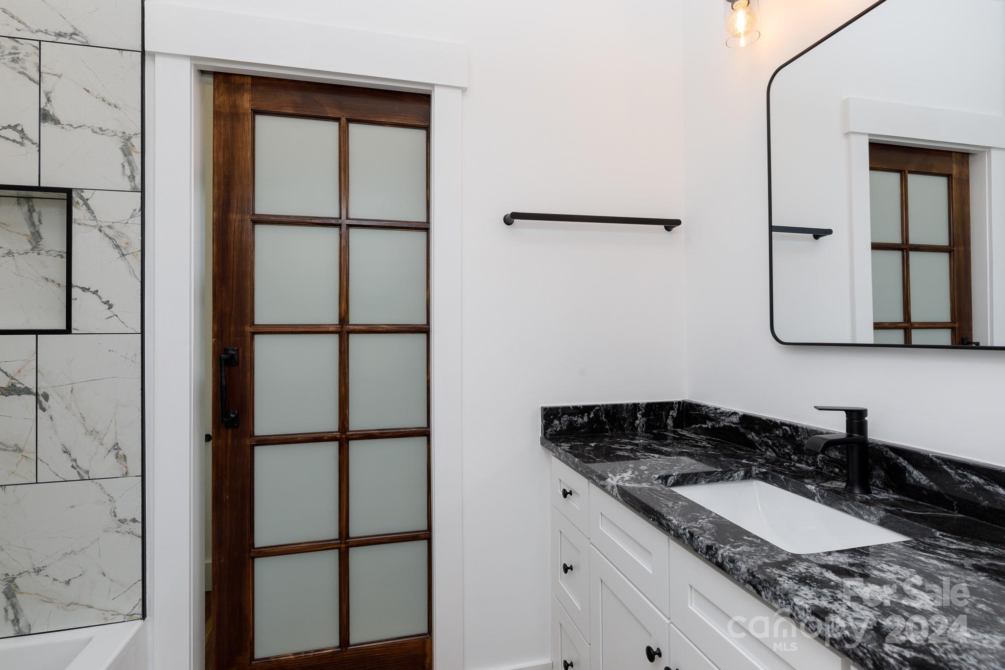 5040 Mt Gallant Road Rock Hill, SC 29732 - Photo 29 of 38 a bathroom with a granite countertop sink and a mirror
