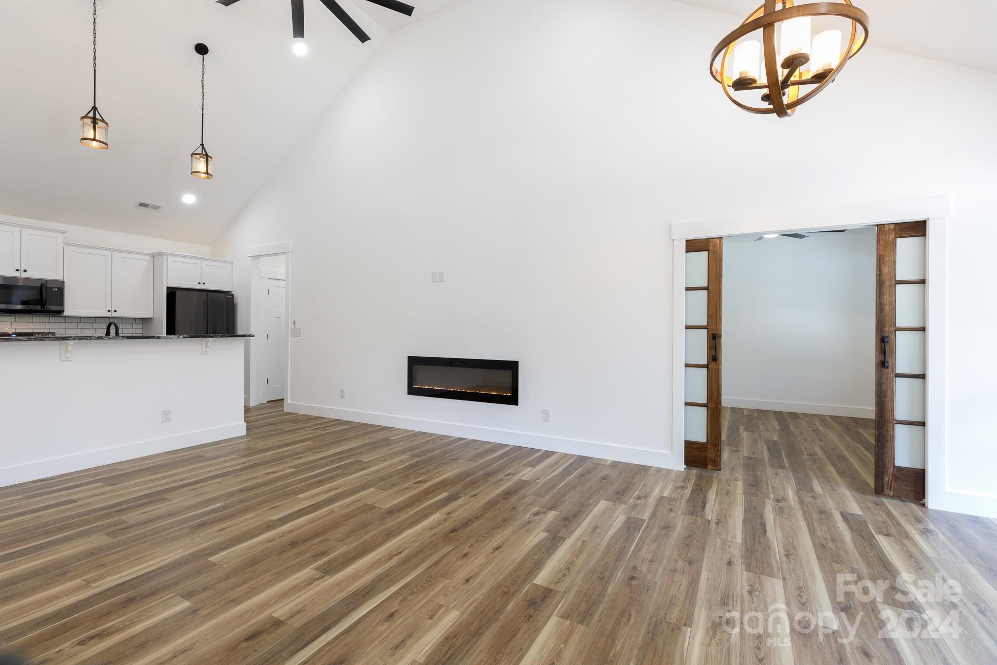 5040 Mt Gallant Road Rock Hill, SC 29732 - Photo 5 of 38 an empty room with wooden floor cabinet and windows