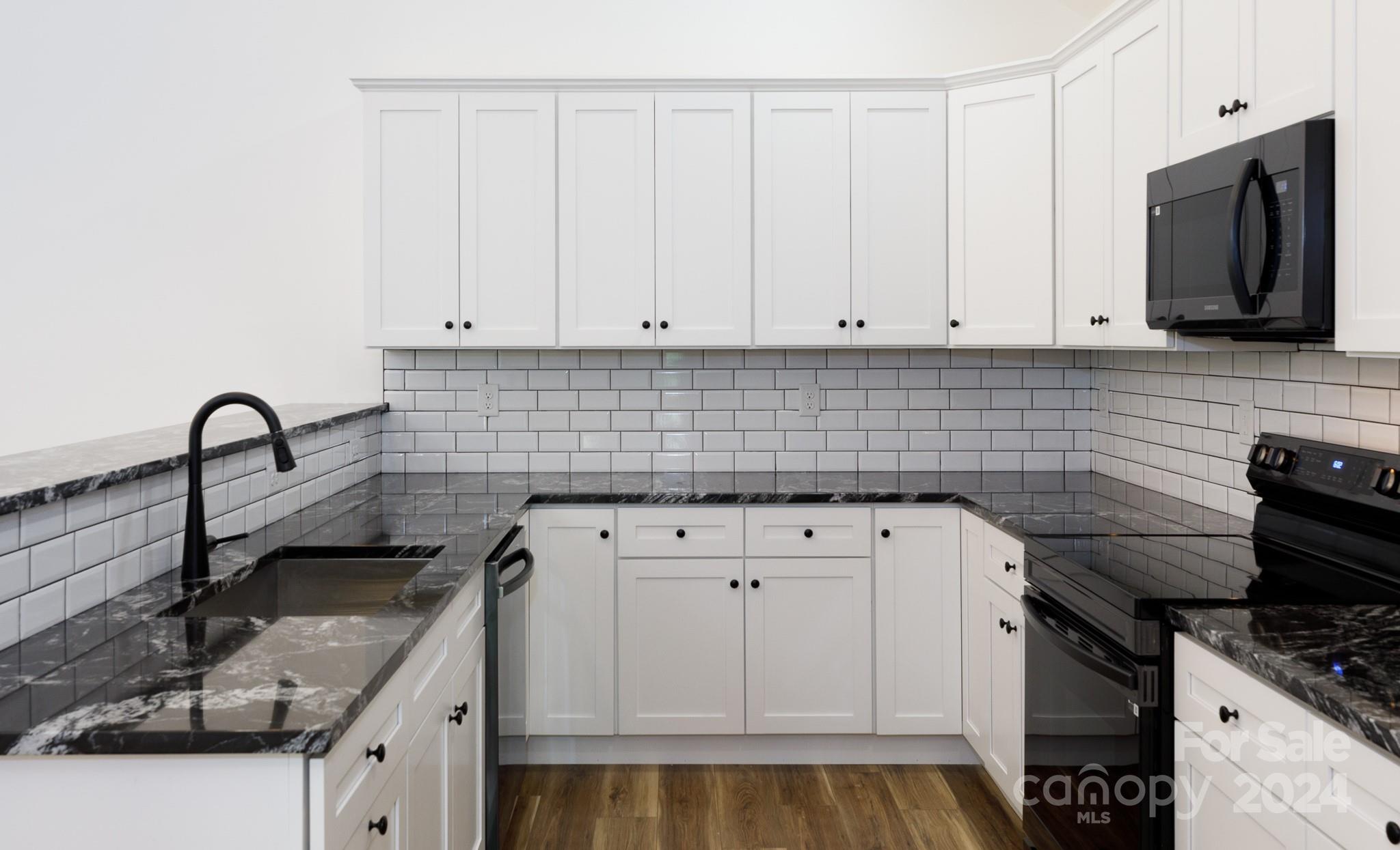 5040 Mt Gallant Road Rock Hill, SC 29732 - Photo 8 of 38 a kitchen with white cabinets and appliances