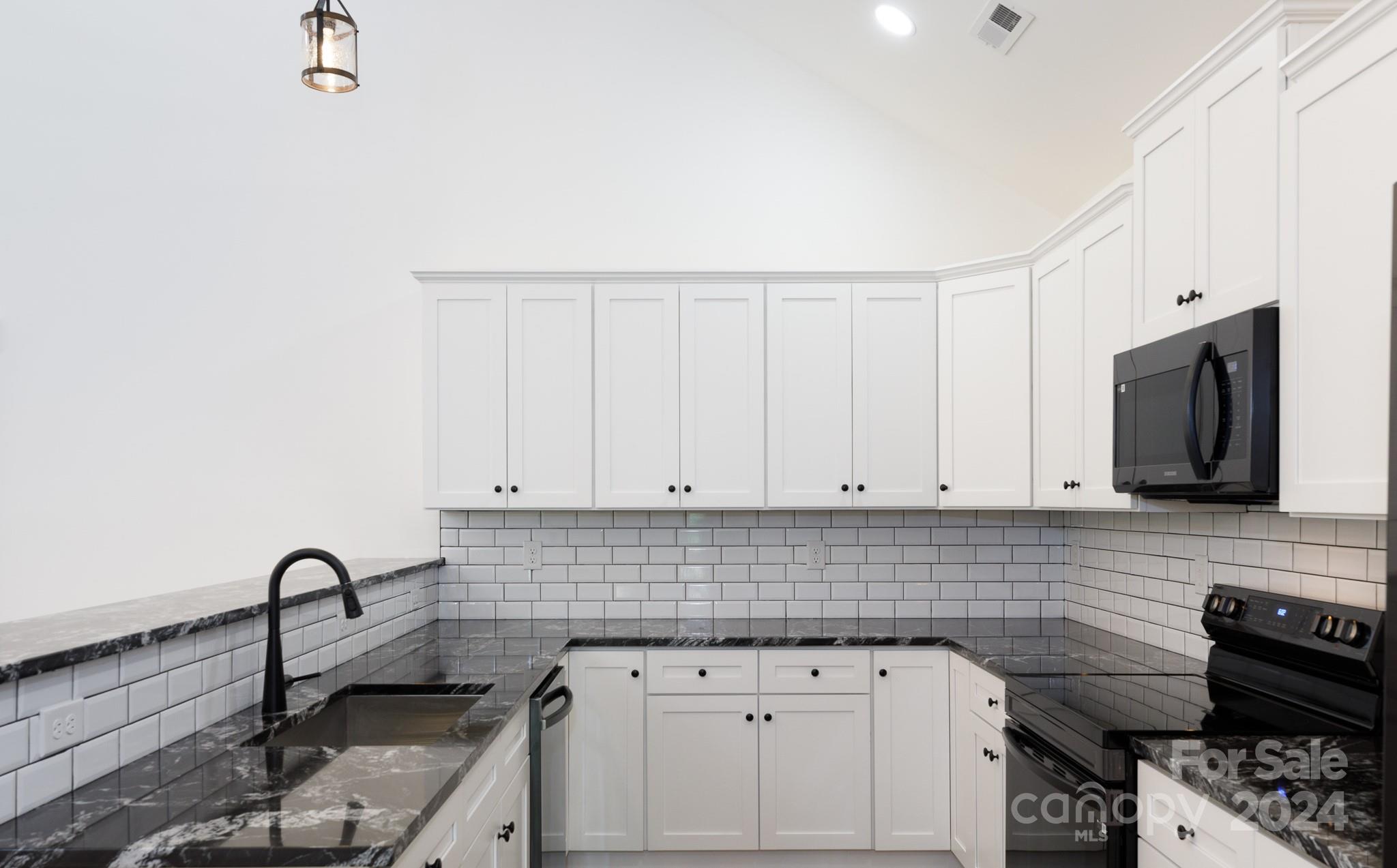 5040 Mt Gallant Road Rock Hill, SC 29732 - Photo 9 of 38 a kitchen with appliances a sink and cabinets