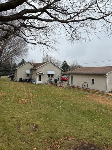 a front view of house with yard and trees
