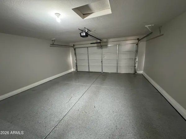 an empty room with chandelier fan