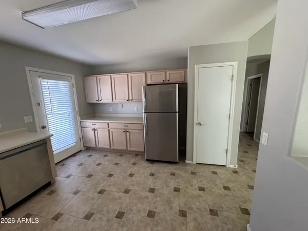a kitchen with a refrigerator a stove a sink and a window