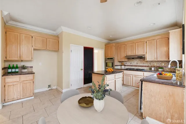 a kitchen with stainless steel appliances granite countertop a sink stove and cabinets