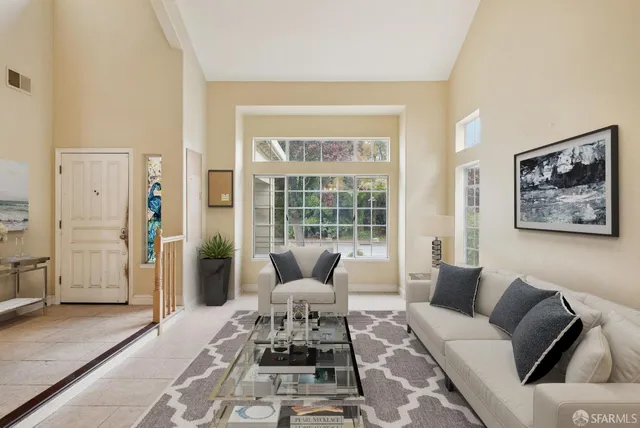 a large white kitchen with granite countertop a stove a sink and a wooden floors