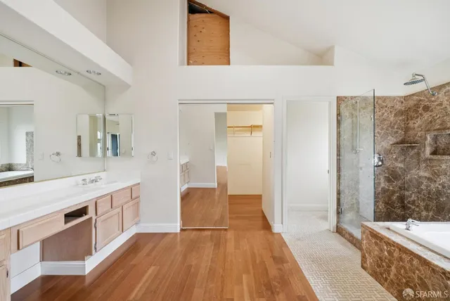 a view of a room that has a window and wooden floor