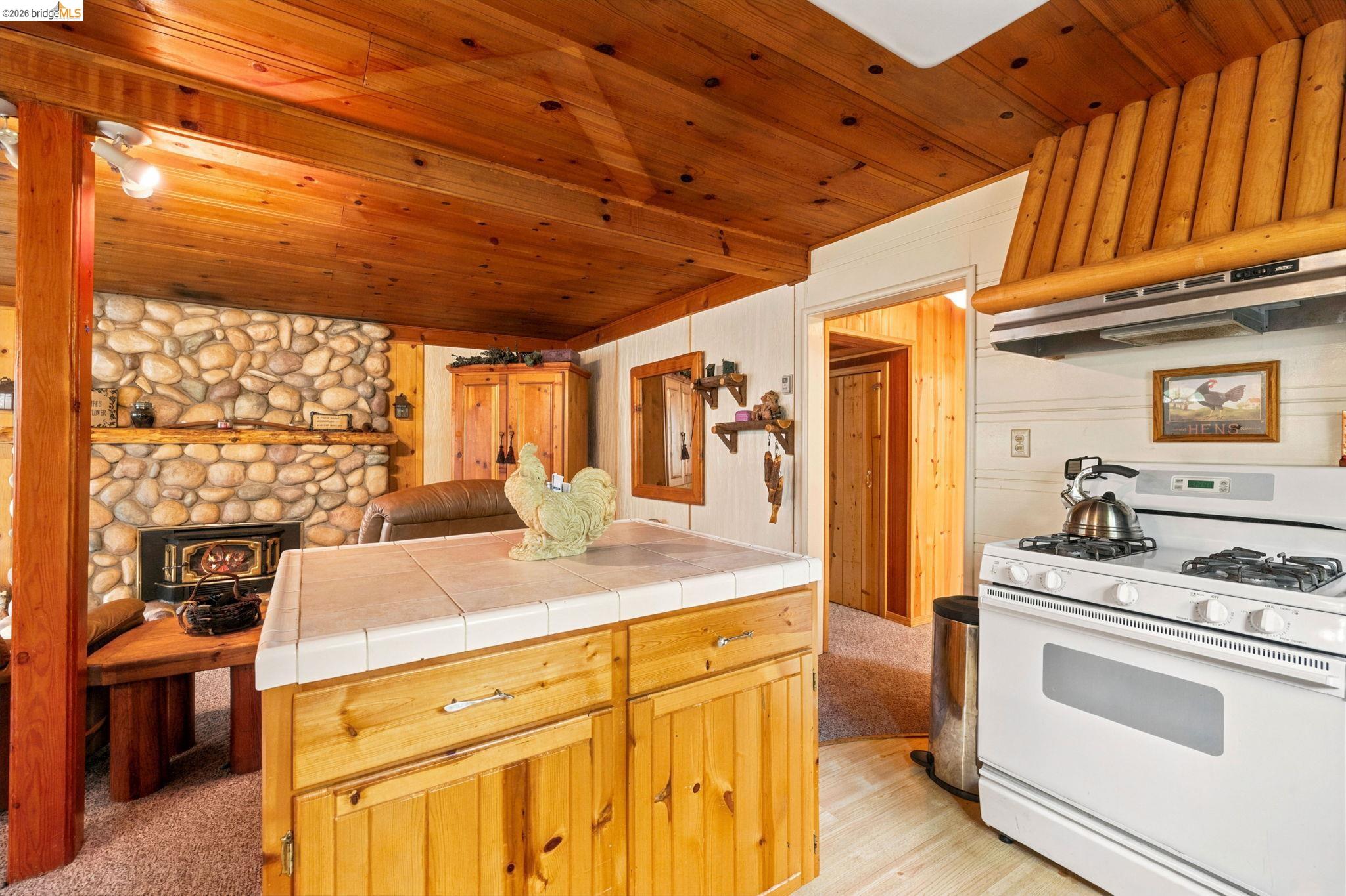 25822 Long Barn Sugar Pine Road Long Barn, CA 95335 - Photo 13 of 28 a kitchen with a sink stove and cabinets