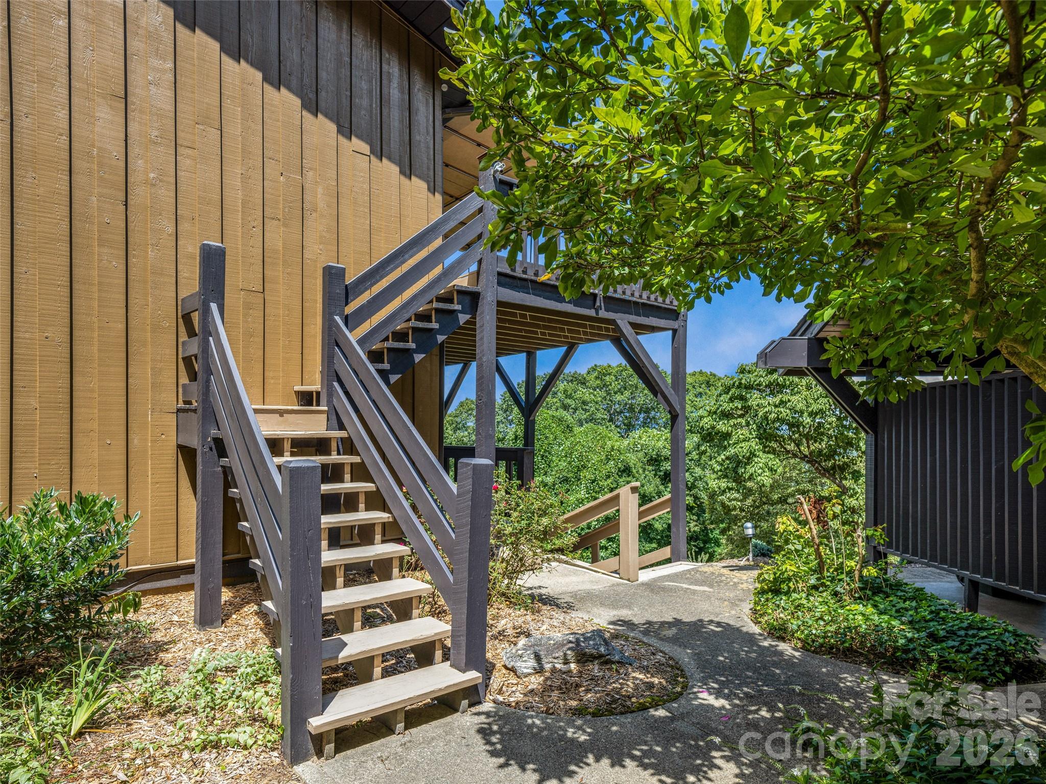 128 Country Ridge Road Hendersonville, NC 28739 - Photo 5 of 48 a view of stairs and flowers with wooden floor