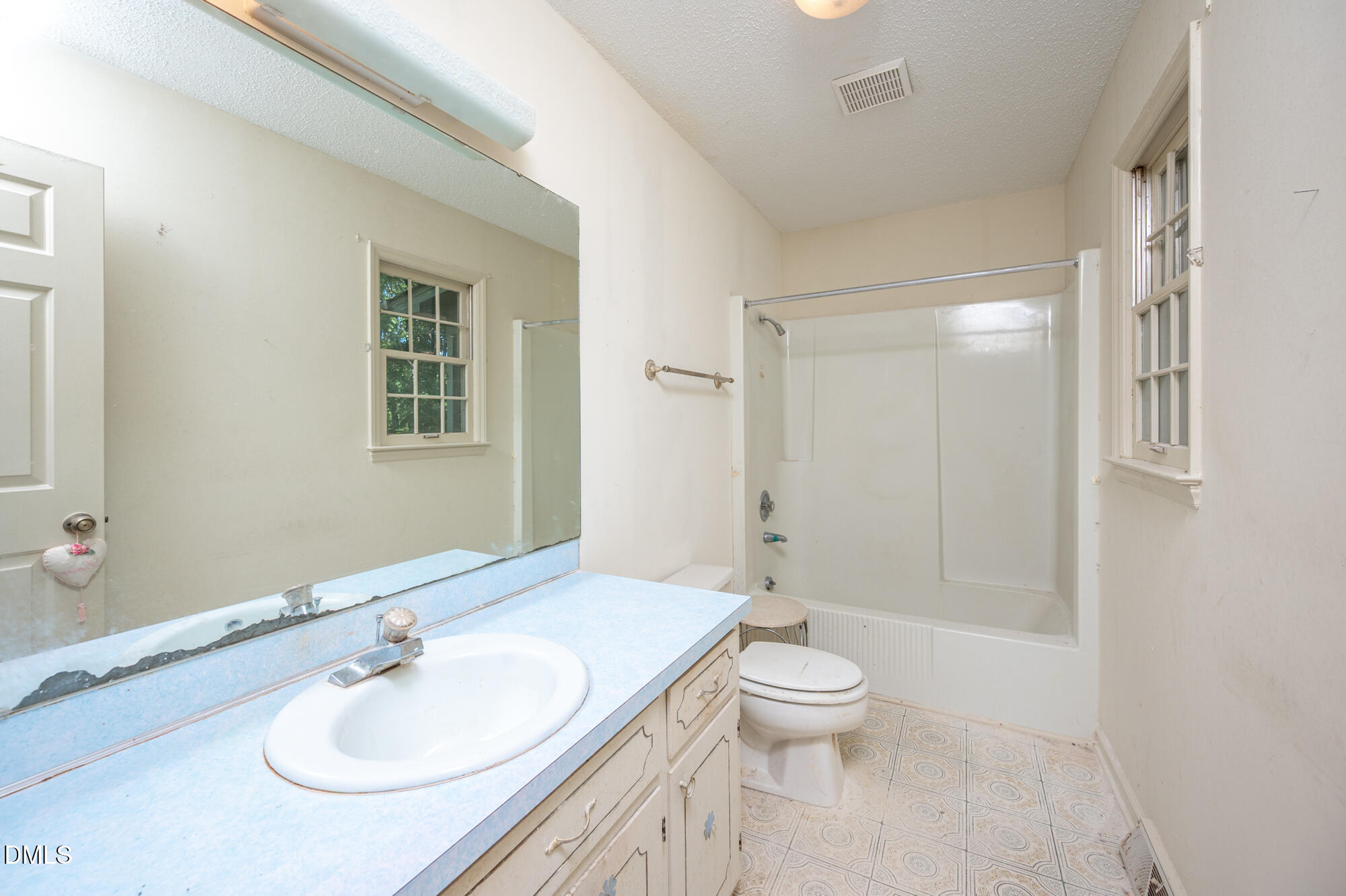 4411 Rhew Drive Durham, NC 27704 - Photo 25 of 34 a bathroom with a sink a toilet and shower
