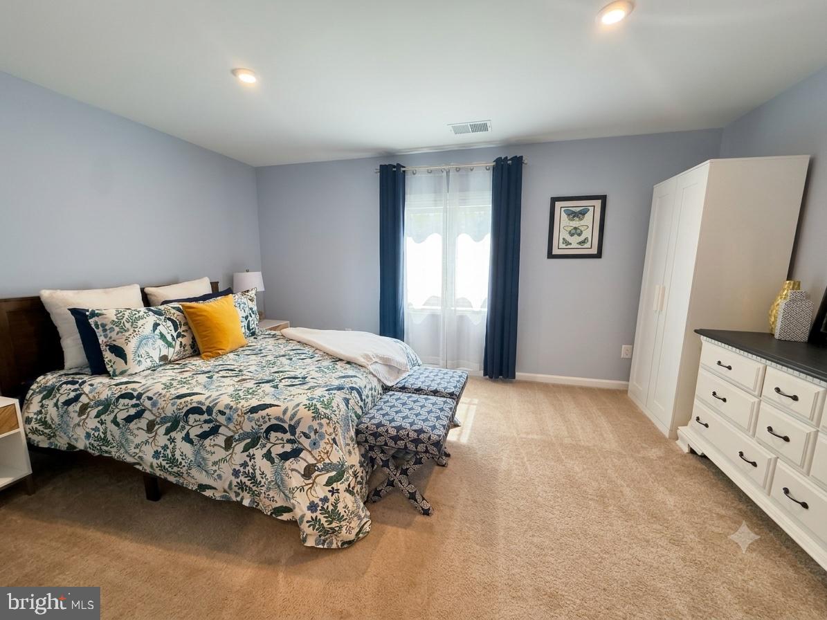 17875 Sugarberry Road Dumfries, VA 22026 - Photo 22 of 30 a bedroom with a bed and wooden floor