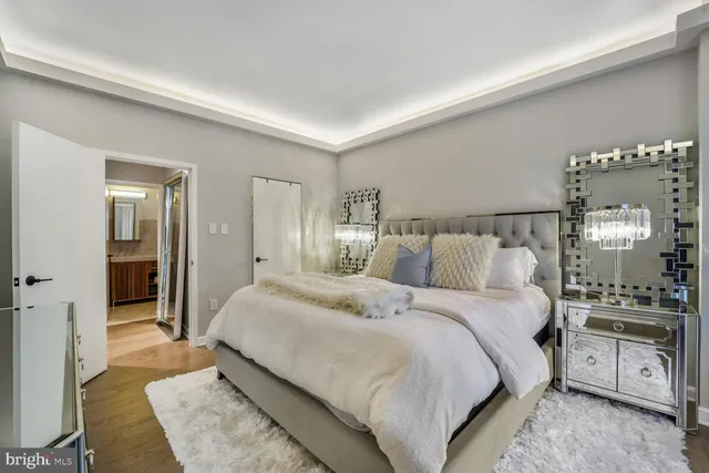 a spacious bedroom with a bed and a lamp