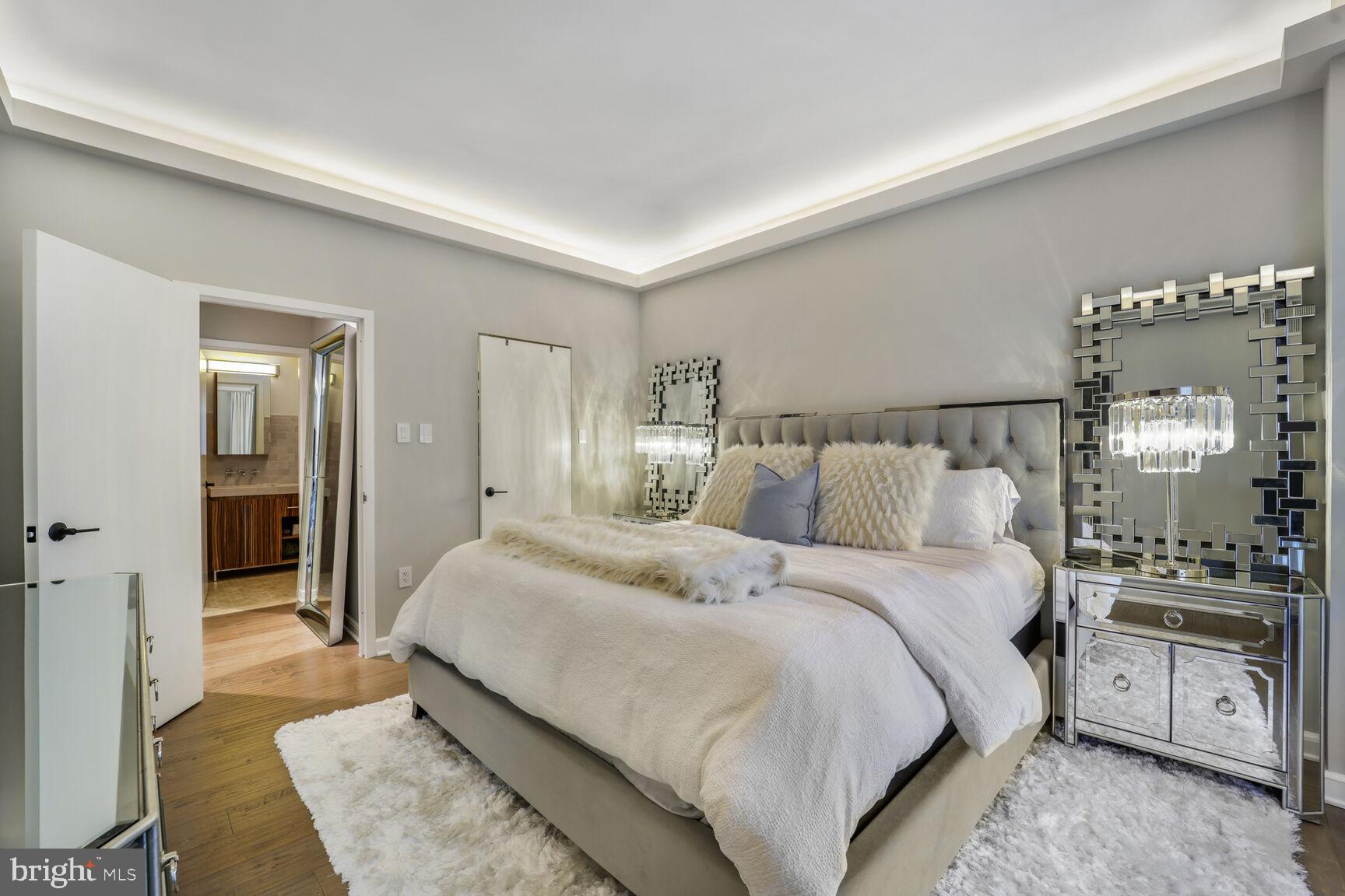 3251 Prospect Street Northwest, Unit 410 Washington, DC 20007 - Photo 11 of 16 a spacious bedroom with a bed and a lamp