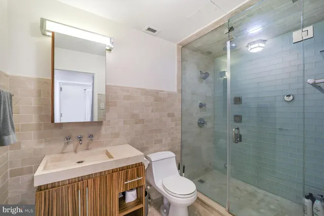 a bathroom with a sink toilet and shower