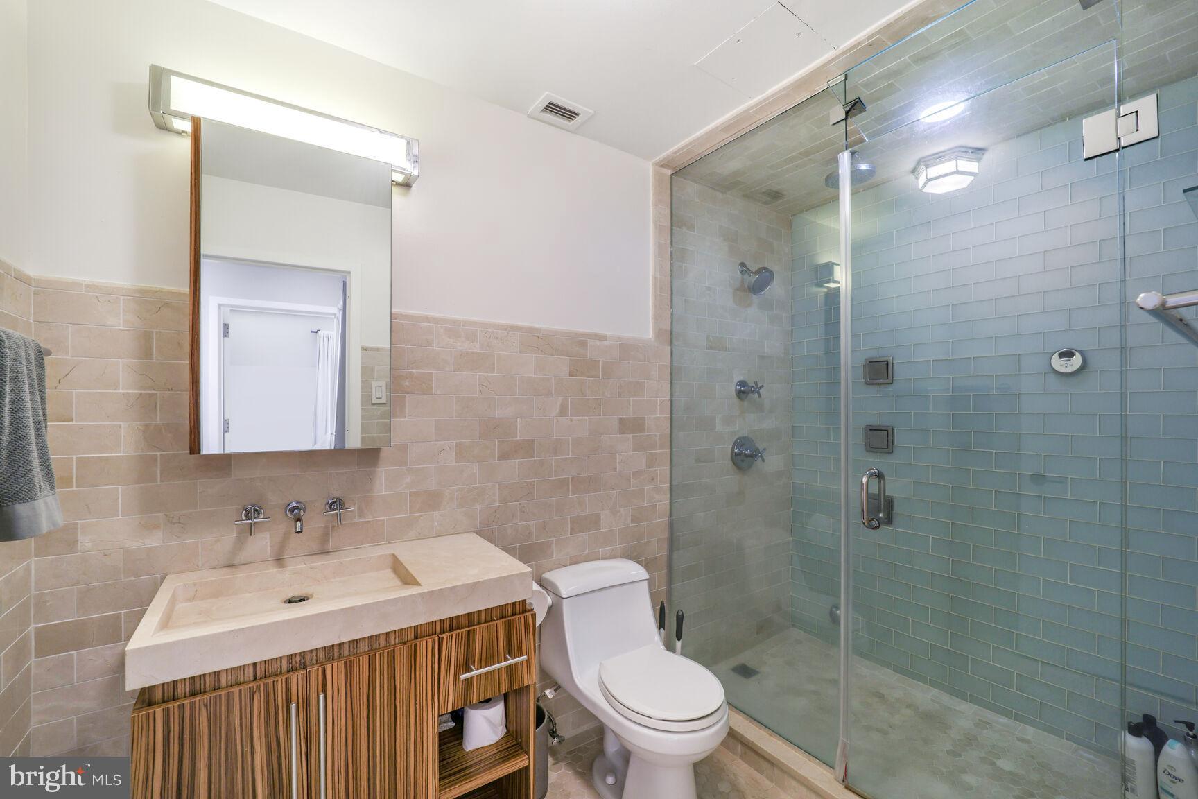 3251 Prospect Street Northwest, Unit 410 Washington, DC 20007 - Photo 12 of 16 a bathroom with a sink toilet and shower