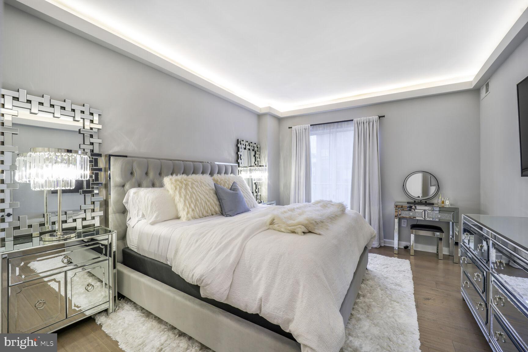 3251 Prospect Street Northwest, Unit 410 Washington, DC 20007 - Photo 10 of 16 a bedroom with a bed and wooden floor