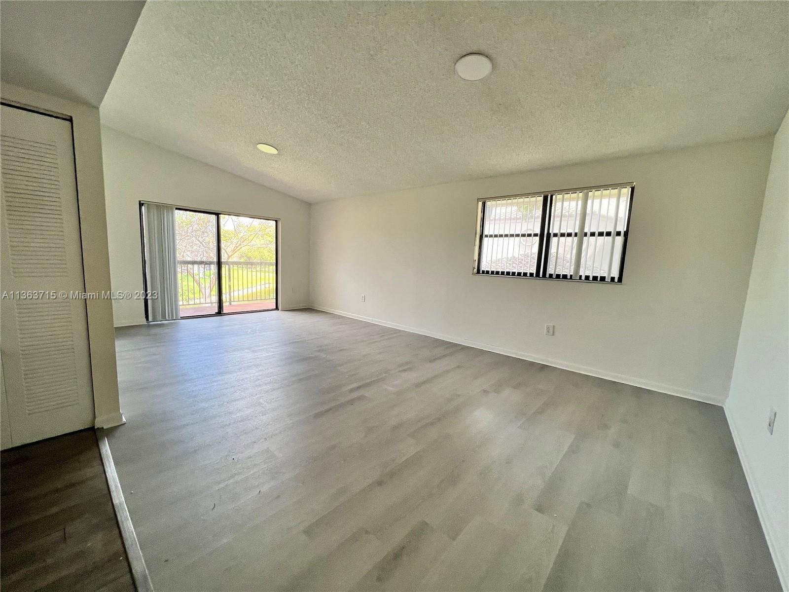 Welleby Sunrise, FL 33351 - Photo 2 of 13 an empty room with wooden floor and windows