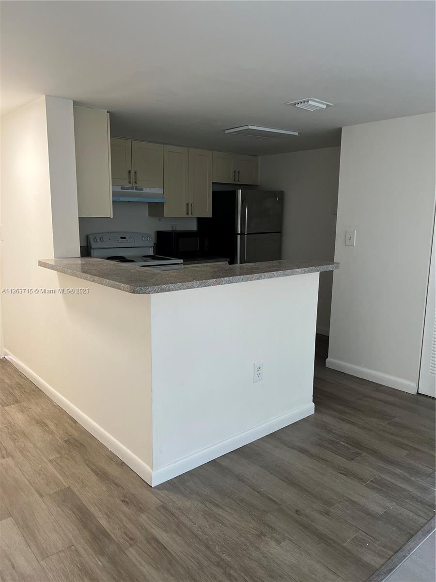 Welleby Sunrise, FL 33351 - Photo 3 of 13 a view of kitchen with wooden floor