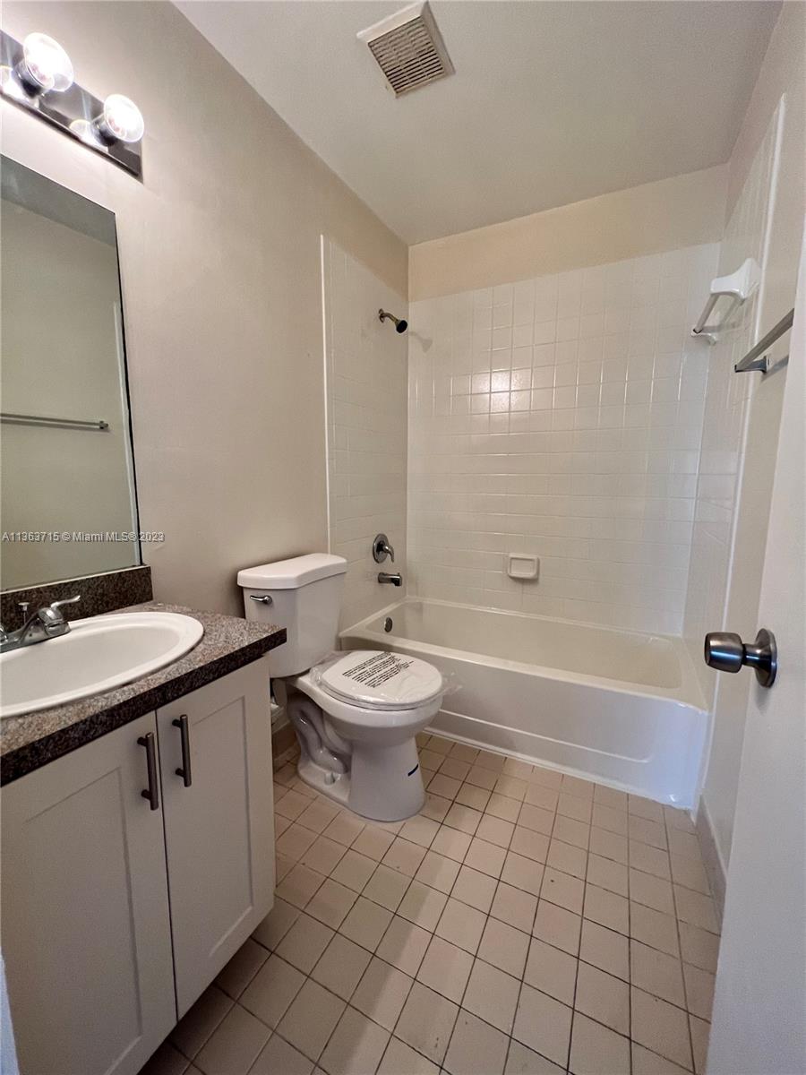 Welleby Sunrise, FL 33351 - Photo 9 of 13 a bathroom with a sink a toilet and shower