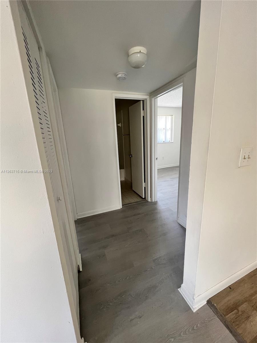Welleby Sunrise, FL 33351 - Photo 10 of 13 a view of a hallway with wooden shelves