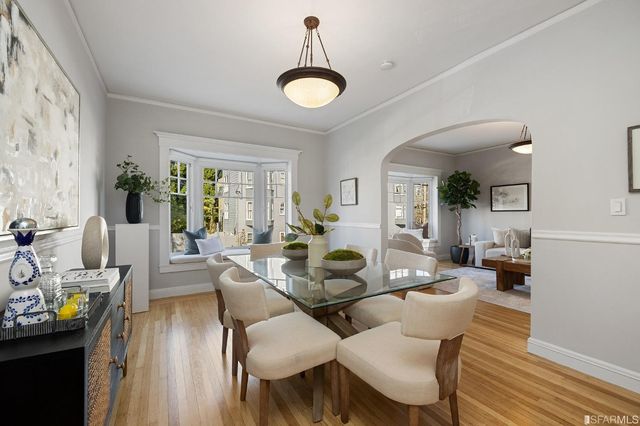 a view of a dining room with furniture window and wooden floor