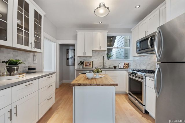 a kitchen with a sink stove and refrigerator