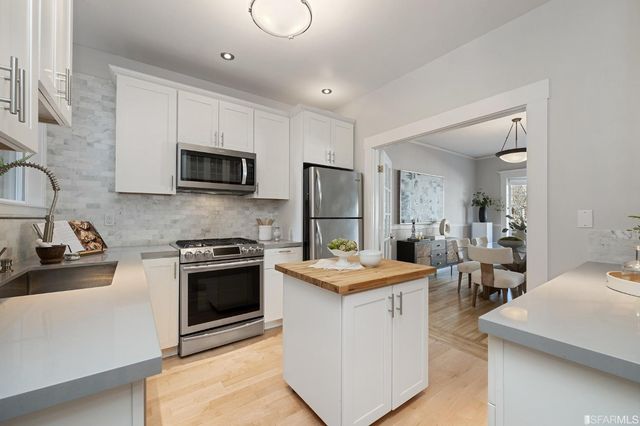 a kitchen with a sink stove and refrigerator