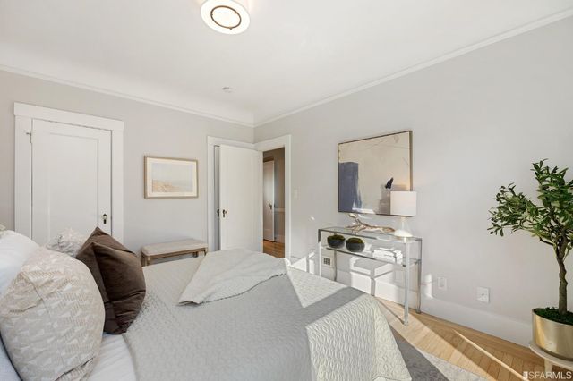 a bedroom with a bed and a potted plant