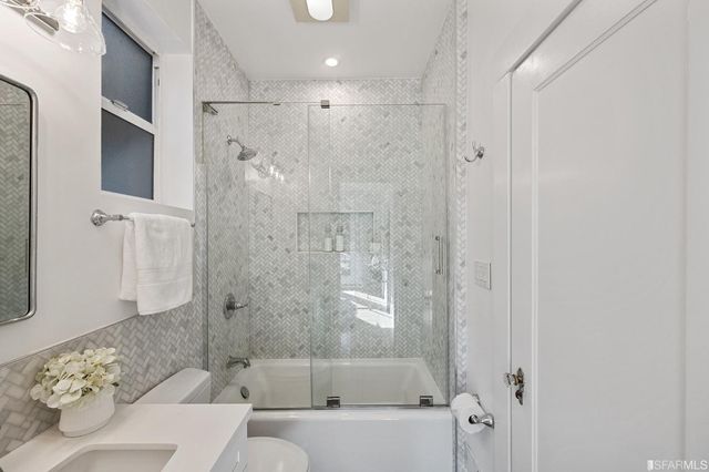 a bathroom with a bathtub and shower