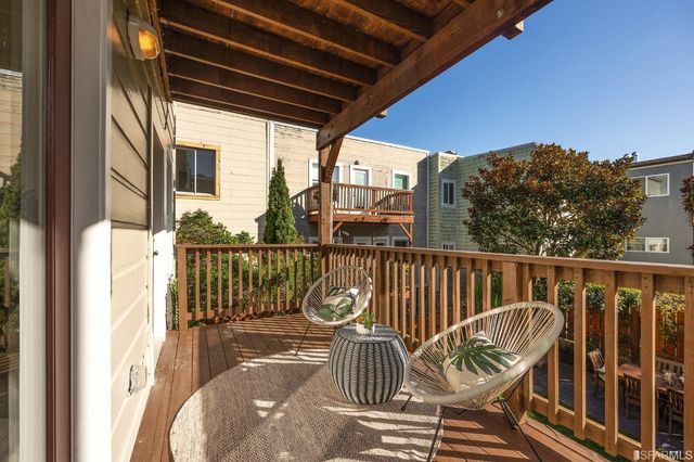 a view of a balcony with wooden floor