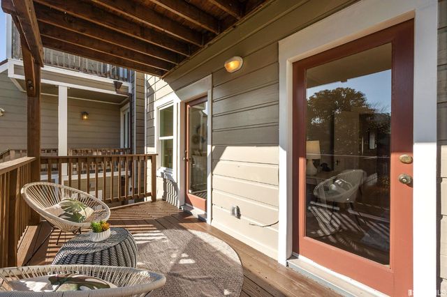 a view of balcony with two chairs and a rug
