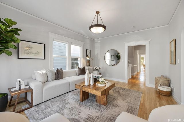 a living room with furniture a rug and a large window