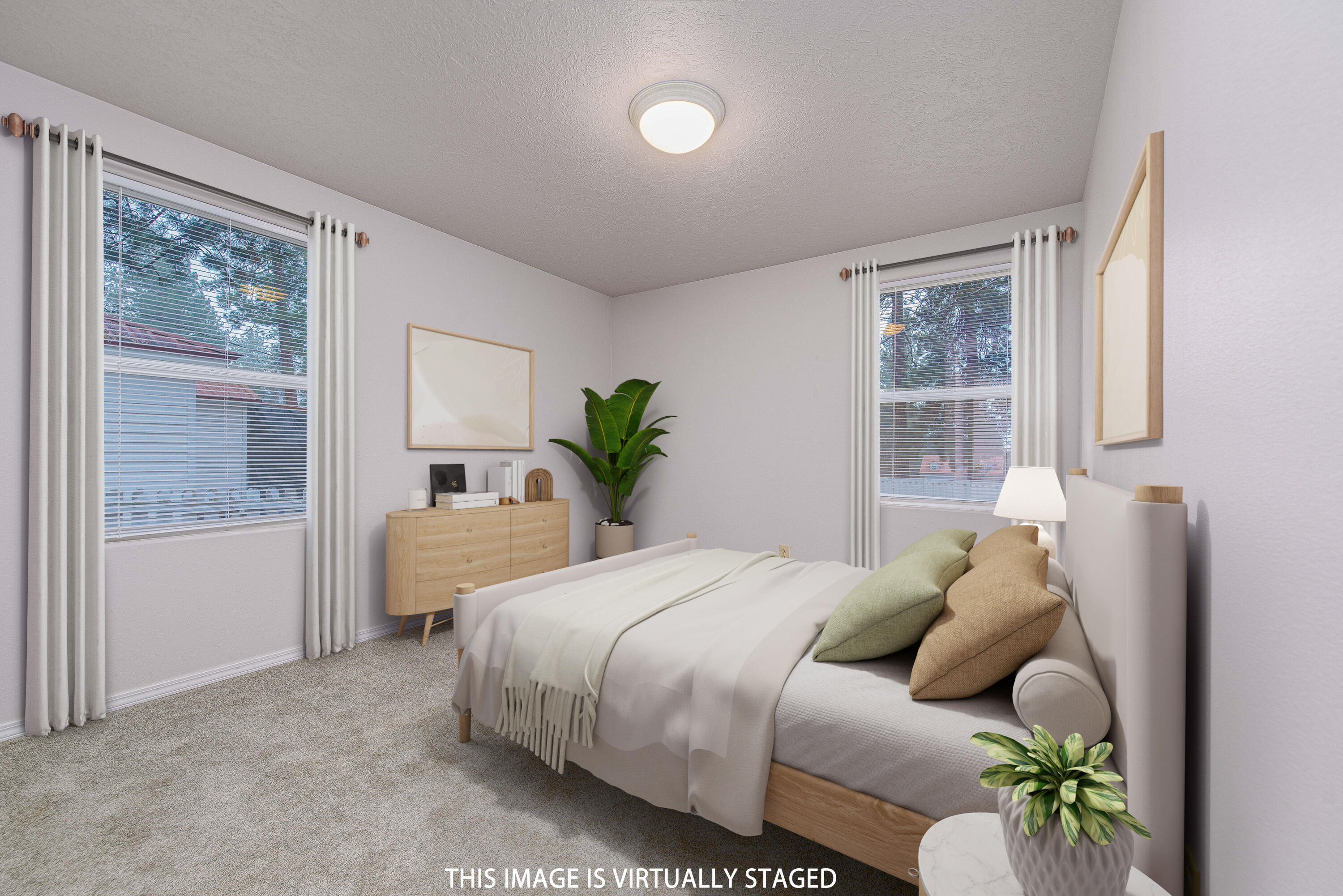 138722 Rhododendron Street Gilchrist, OR 97737 - Photo 25 of 36 a bedroom with a bed and potted plant