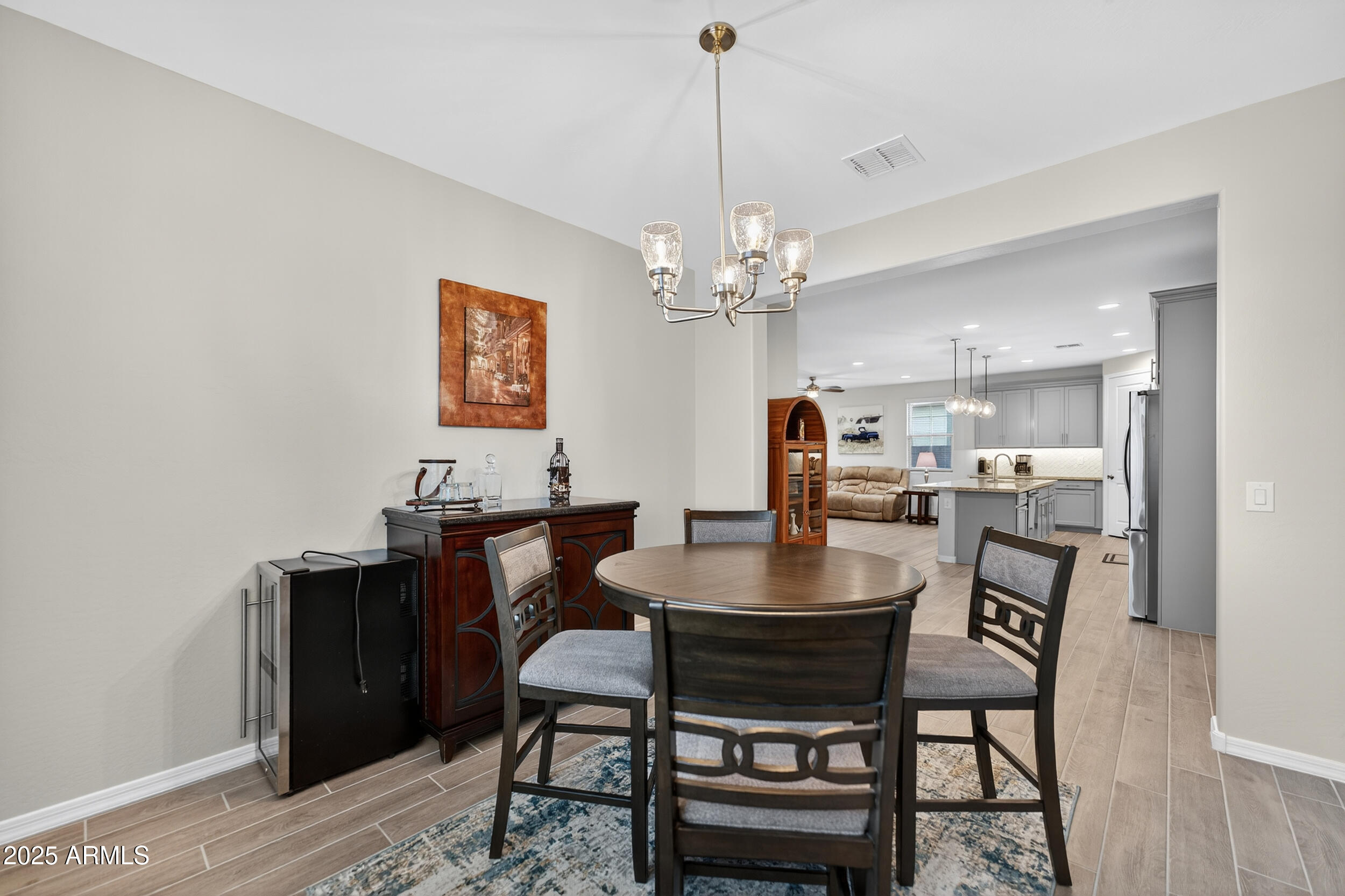 10218 West Piccadilly Road Avondale, AZ 85392 - Photo 11 of 28 a view of a dining room with furniture and wooden floor
