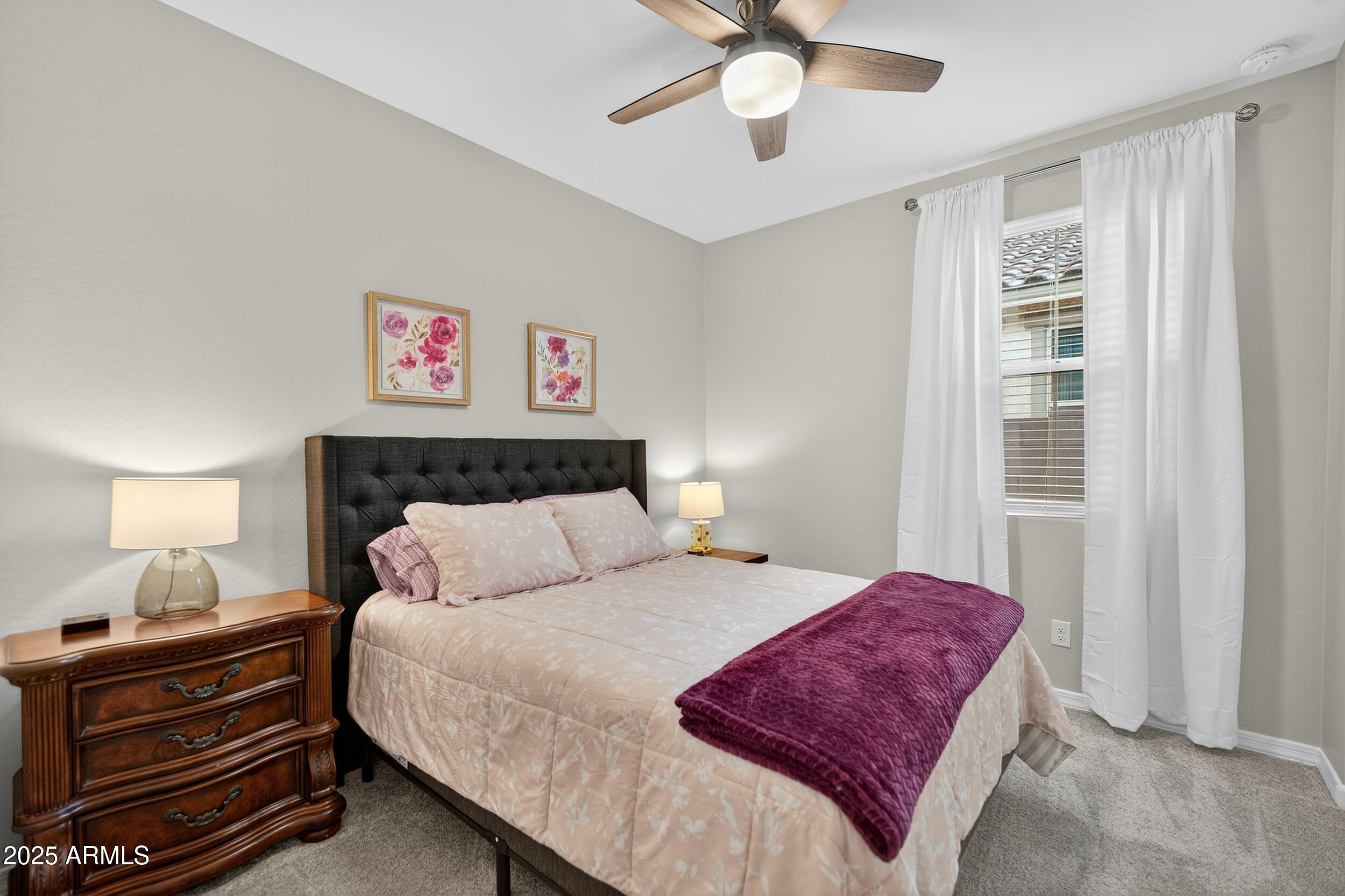 10218 West Piccadilly Road Avondale, AZ 85392 - Photo 13 of 28 a bedroom with a bed and a chandelier